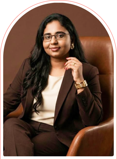 Sindhuja, founder of Plarty, seated and smiling in a professional portrait